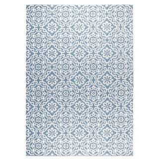 Blue gray patterned outdoor rug shown as a quiet luxury garden accessory