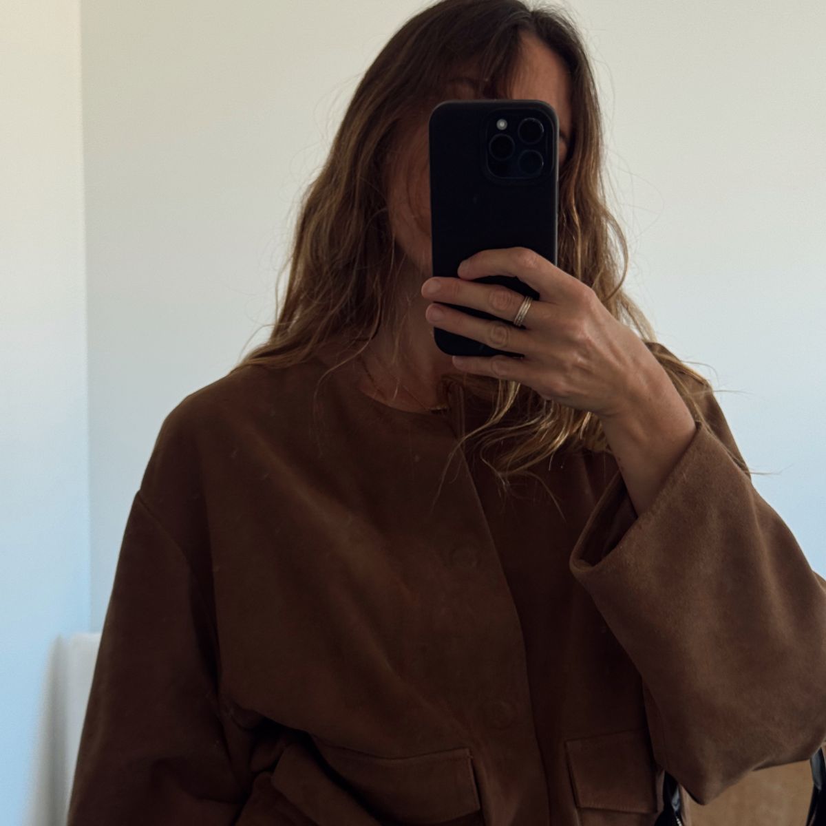 Angie wears a brow suede jacket