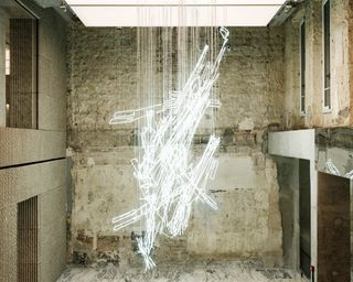 Light sculpture suspended amid bare walls