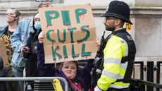 Disabled people protest outside Downing Street against cuts to welfare benefits