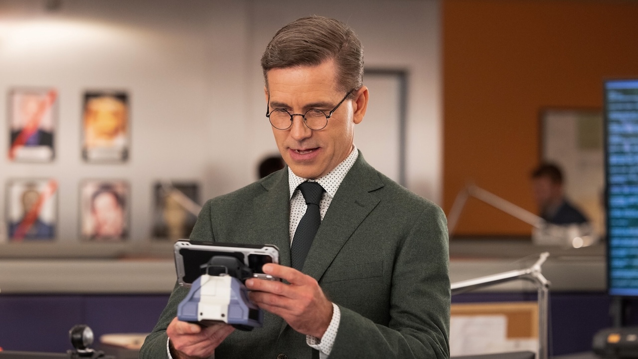 Jimmy Palmer holding up DAWN AI phone in NCIS