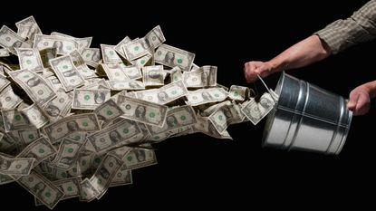 A man dumps a bucket full of cash.