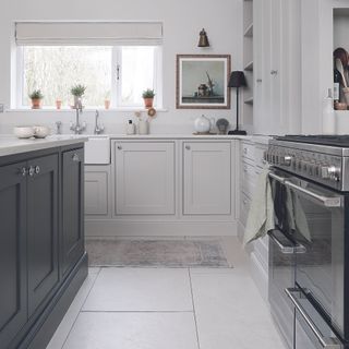 Grey kitchen with black island and black cooker