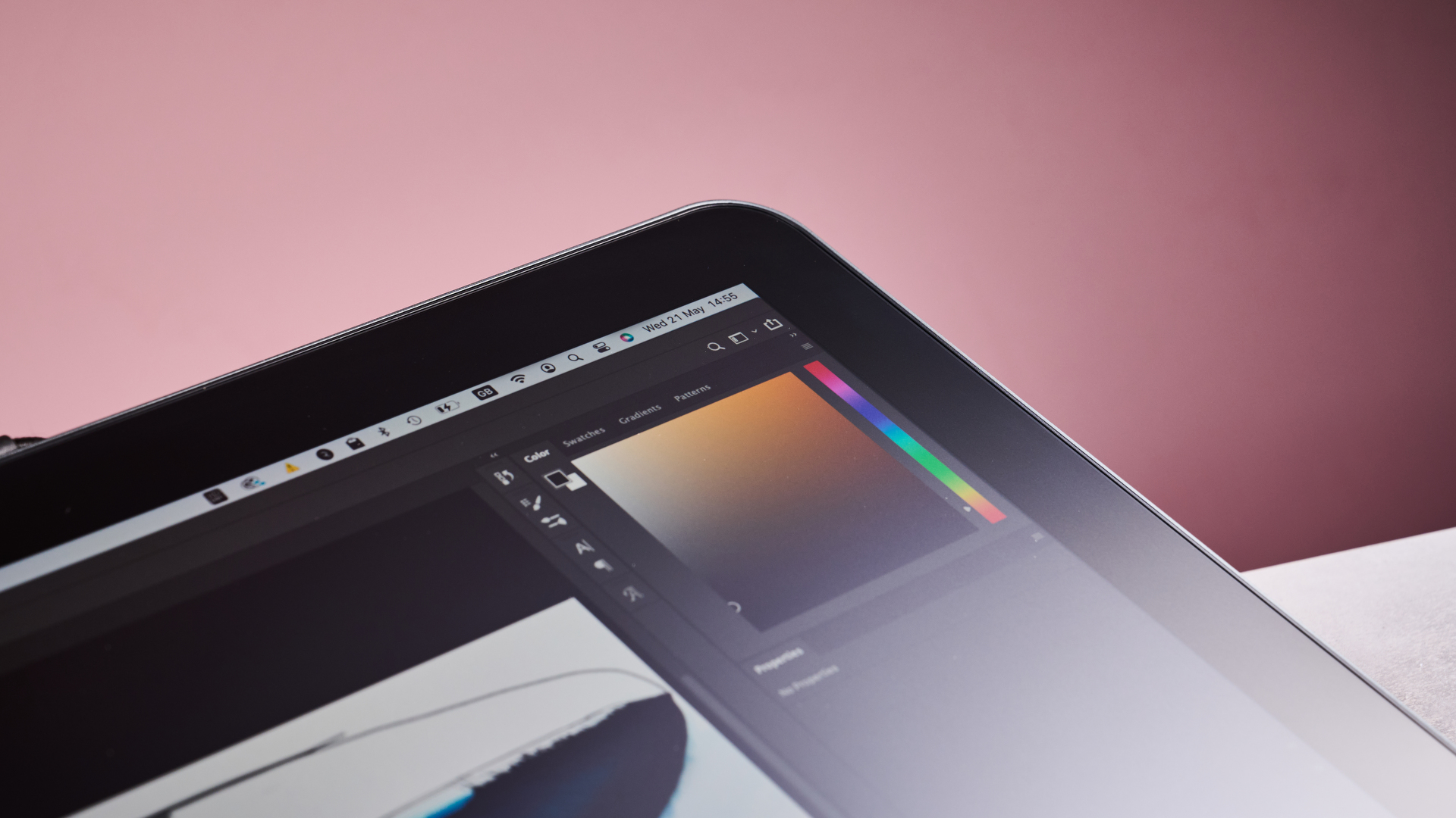 A closeup of the corner of the XPPen Artist Pro 19 Gen 2 in front of a pink background.