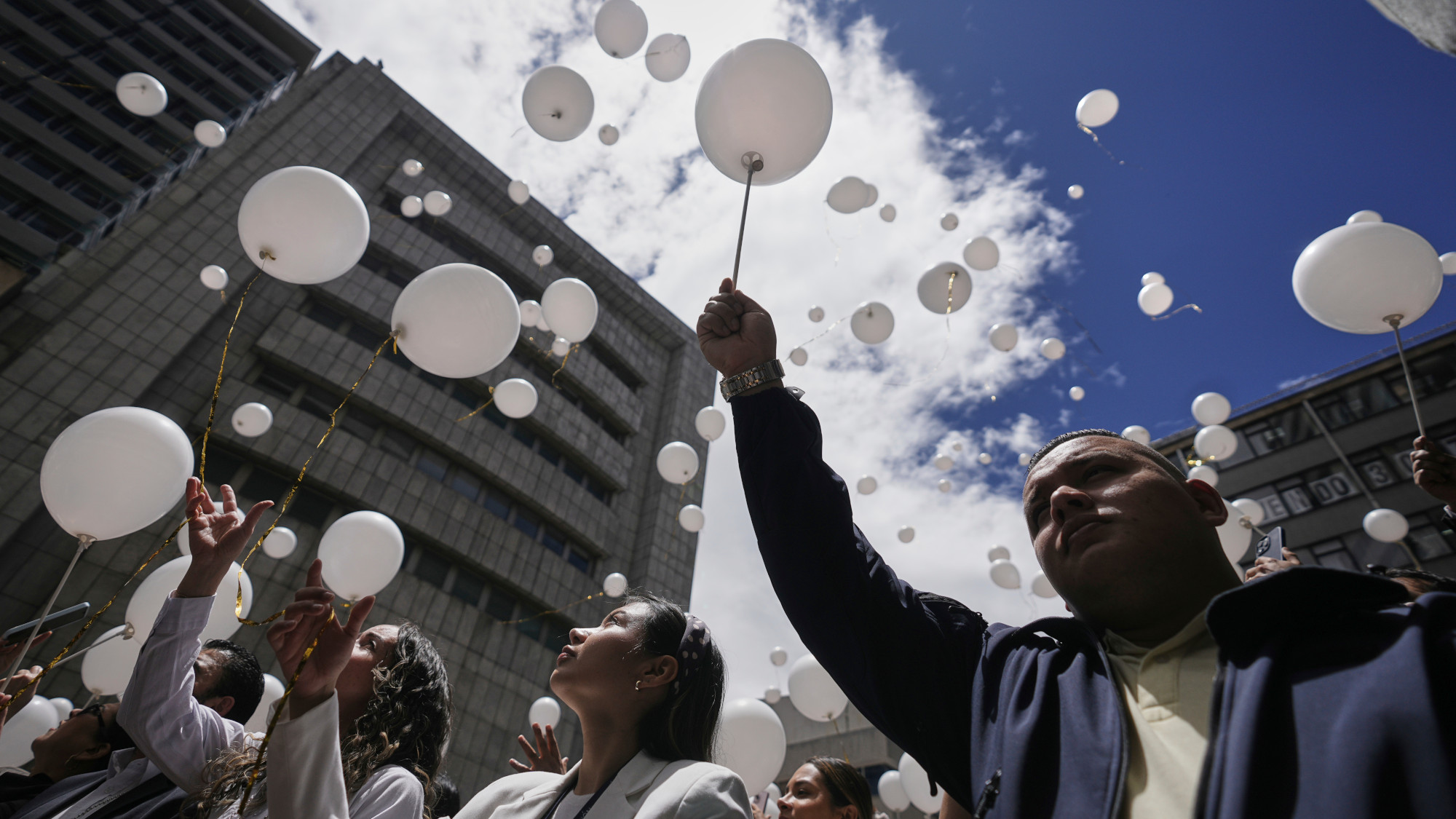 People releasing balloons
