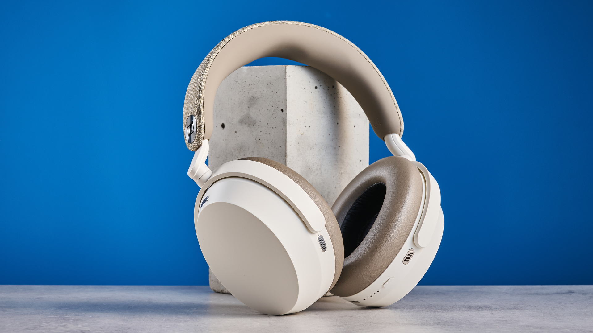 the sennheiser momentum 5 in white photographed against the blue tom's guide background