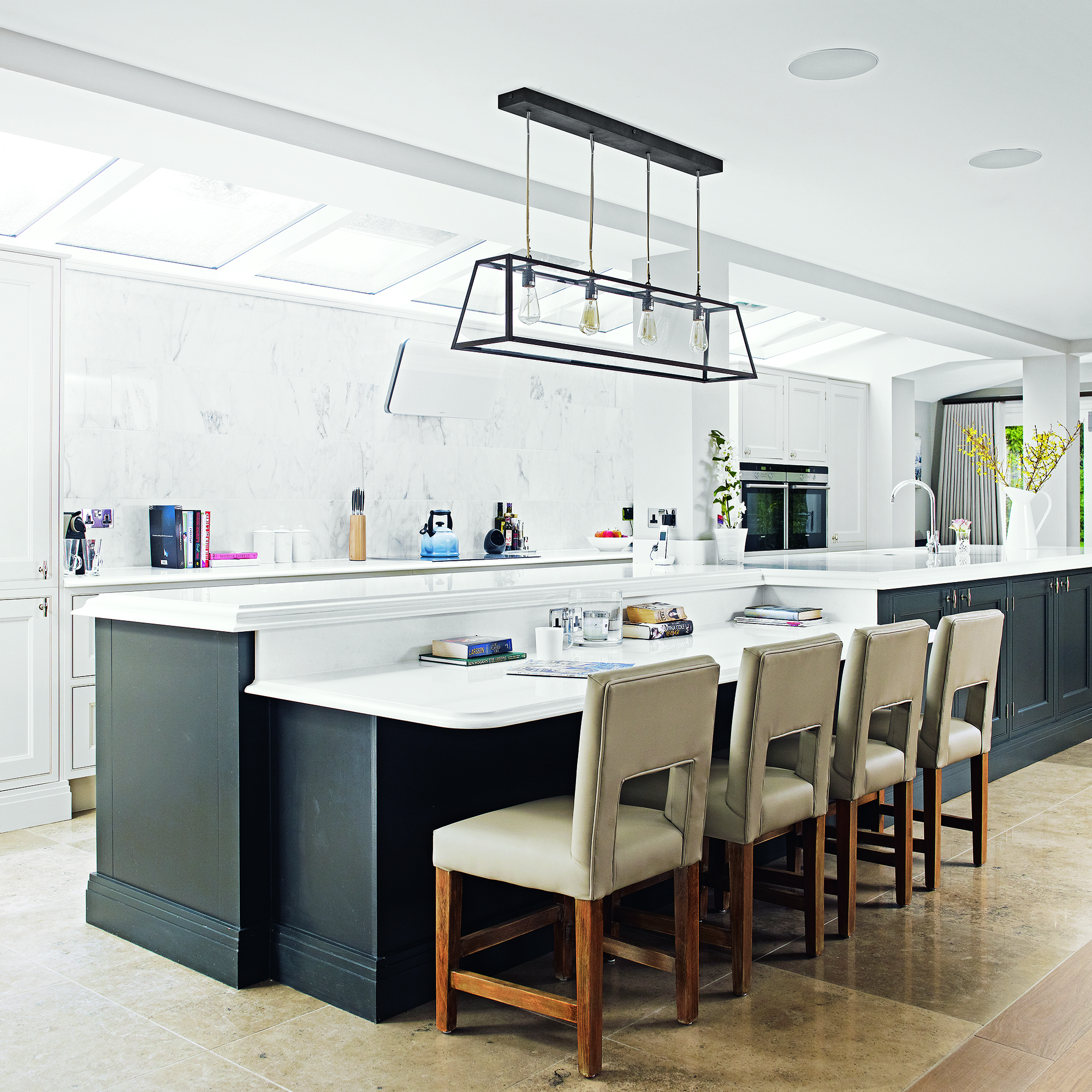 white kitchen with bar and chairs