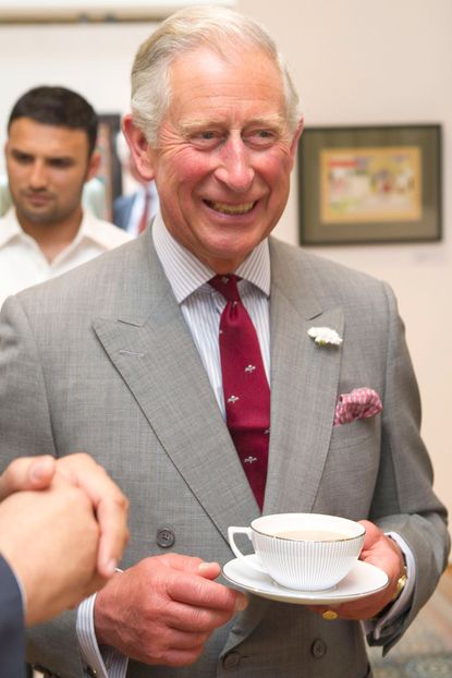 Prince Charles enjoys a cup of tea on a royal visit