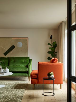 Living room with green and orange velvet sofas