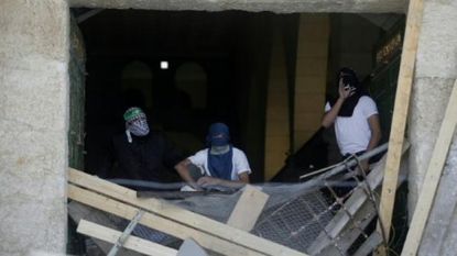 Masked Palestinians at the al-Aqsa mosque in Jerusalem.