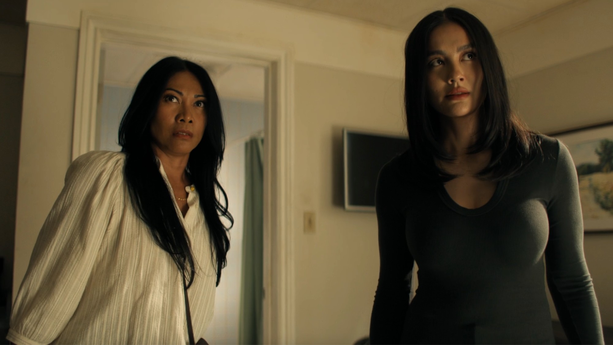 From left to right: Anggun as Amisha and AGNEZ MO as Lila looking concerned in Reacher.