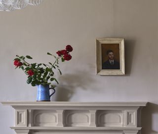 A living room mantelpiece with gold wall art