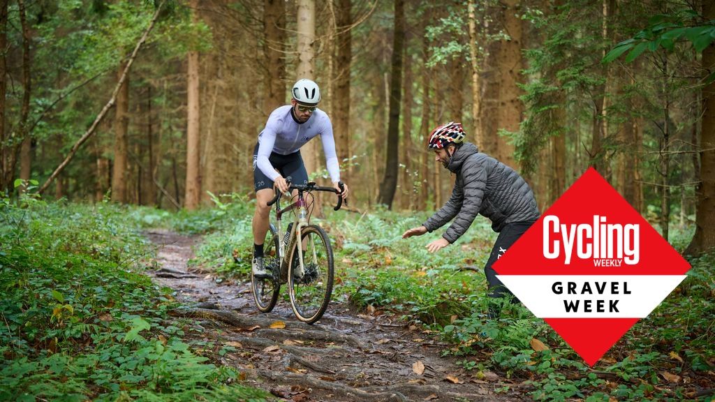 Andy riding down a trail with a coach cheering on