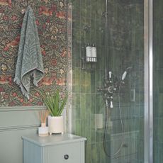 Bathroom with blue wall panelling, wallpaper and green tiles