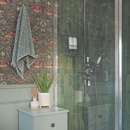 Bathroom with blue wall panelling, wallpaper and green tiles