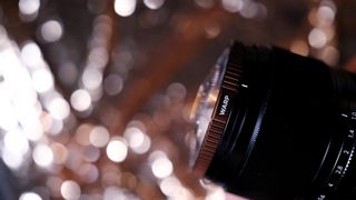 The PolarPro Warp filter on a gold bokeh background