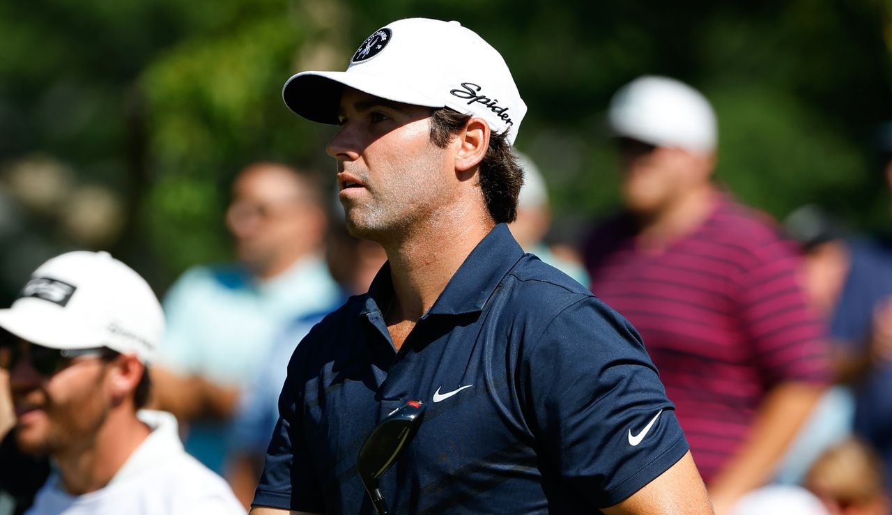 Wolff stares on as he walks off the tee