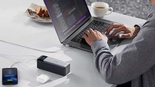 Anker 737 Power Bank charging a laptop and phone.