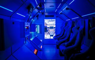 An interior view of the SpaceBuzz cabin, where children and adults can experience space travel as a virtual reality show.