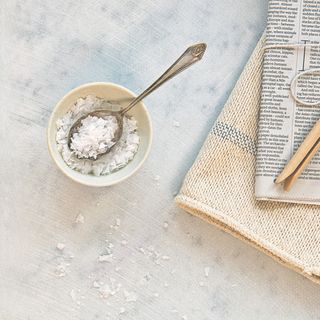 salt in bowl and newspaper