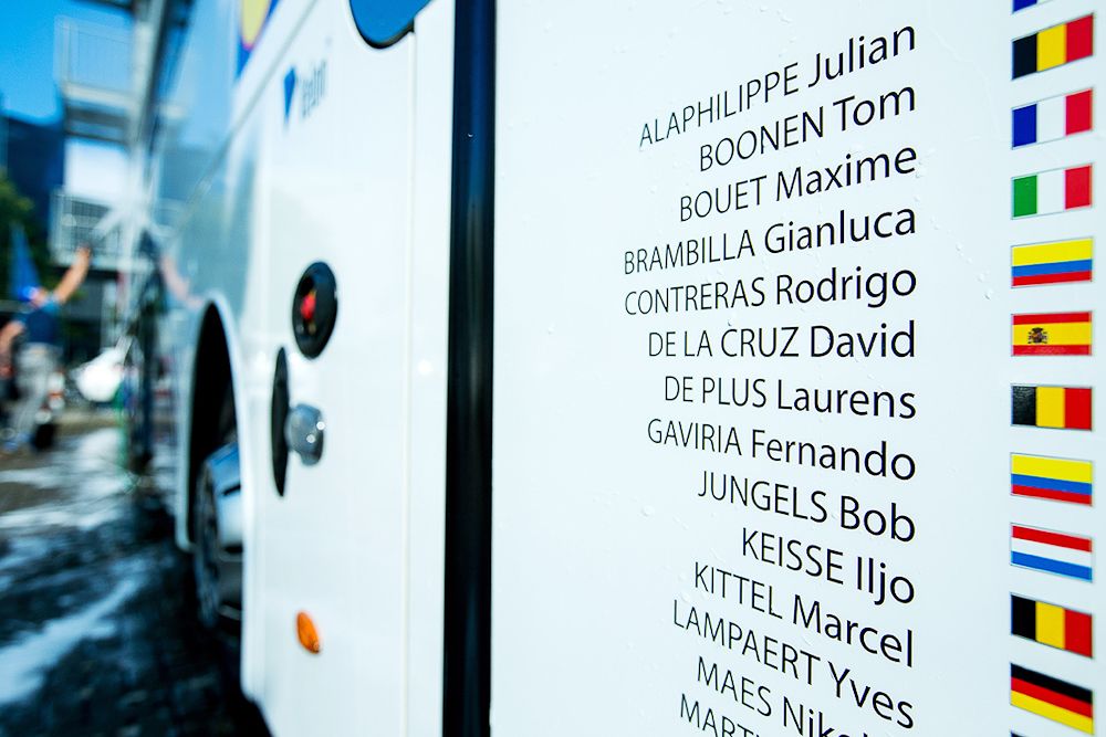 Riders' names are listed on the Etixx-QuickStep bus
