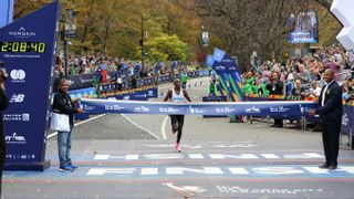 Evans Chebet about to cross the 2022 New York City Marathon finish line, the clock reads 2:08:40