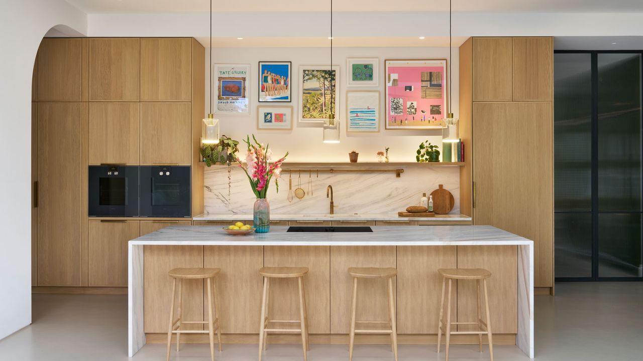 modern wooden kitchen with large kitchen island with four wooden bar stools