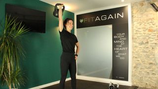 Personal trainer Alanah Bray performs single arm shoulder press