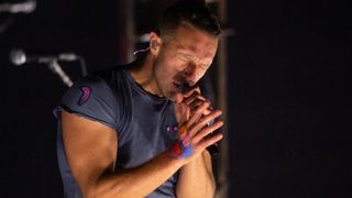 Chris Martin sings in close-up while on the Pyramid Stage at Glastonbury