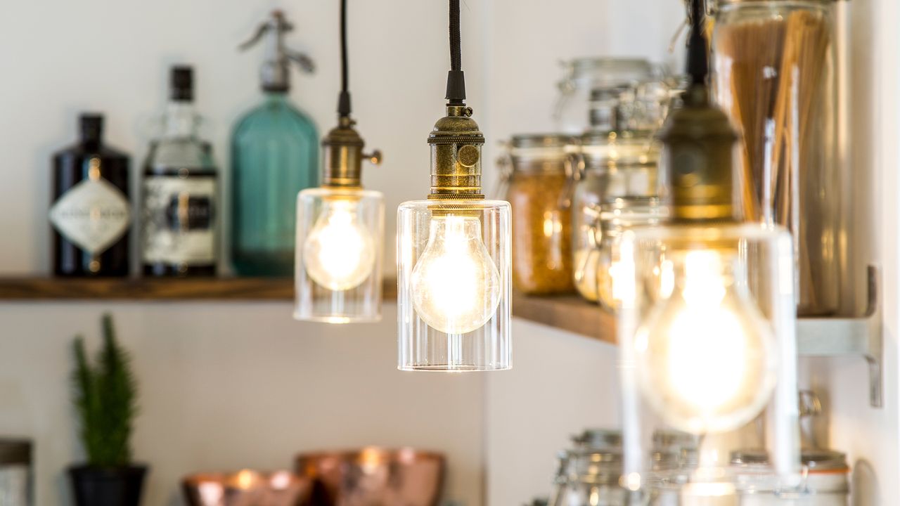 Three pendant lights with glass shades in kitchen 