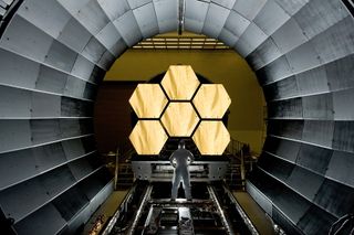 NASA engineer Ernie Wright looks on as the first six flight-ready James Webb Space Telescope's primary mirror segments are prepped for final cryogenic testing at NASA's Marshall Space Flight Center.