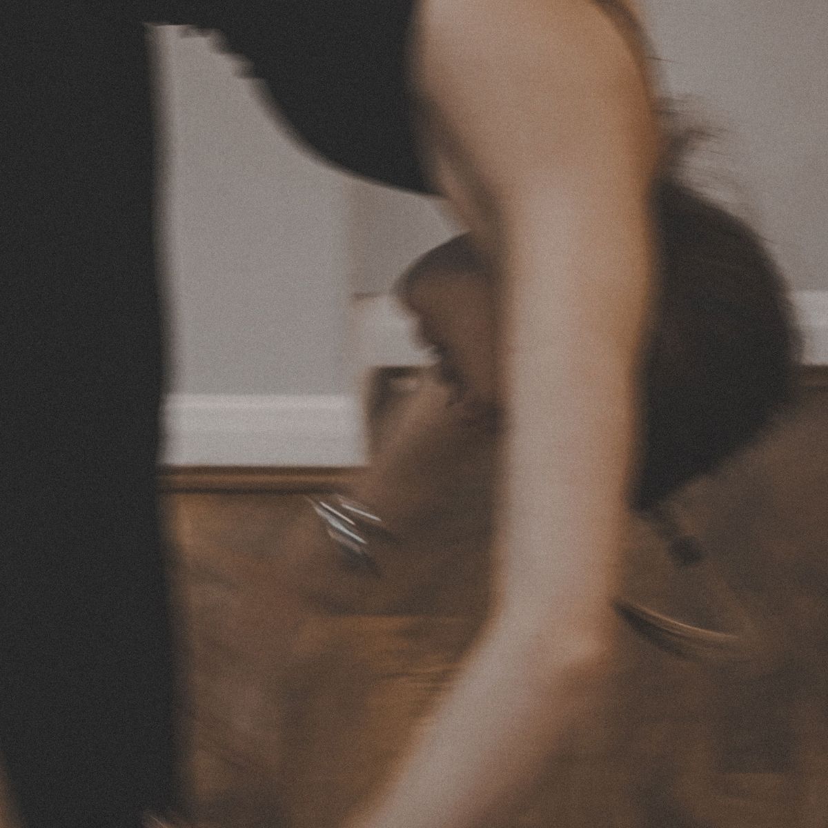 A woman stretching, holding a bundle of health books, and taking some supplements