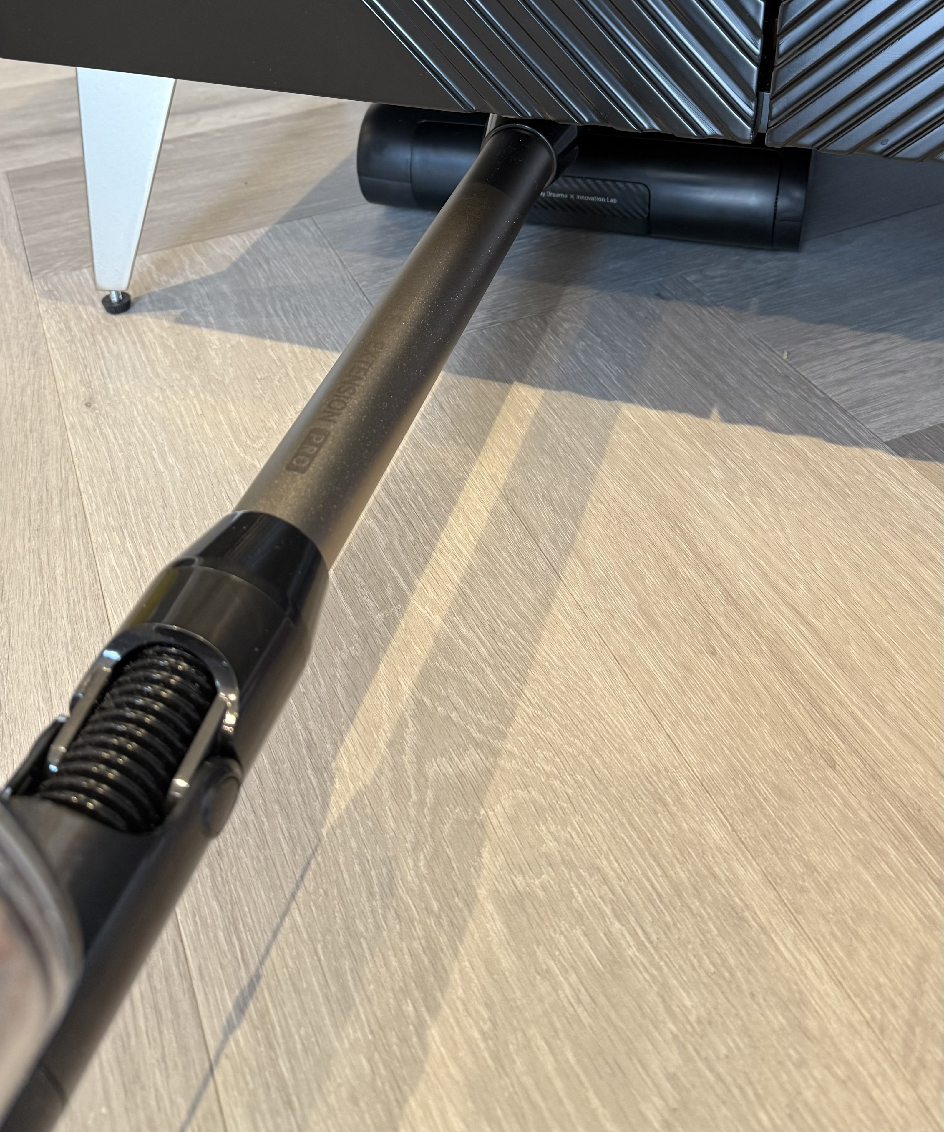 The Dreame Z30 Pro Aqua floor head lying completely flat underneath low furniture
