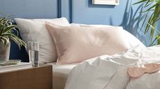 Brooklinen silk pillowcases on a bed.