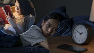 A woman lies in bed in the middle of the night, staring at the clock. In the top left corner, an image of a woman sitting up and reading a book during the night