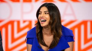 priyanka chopra laughing on a chat show with a soft oval layered haircut