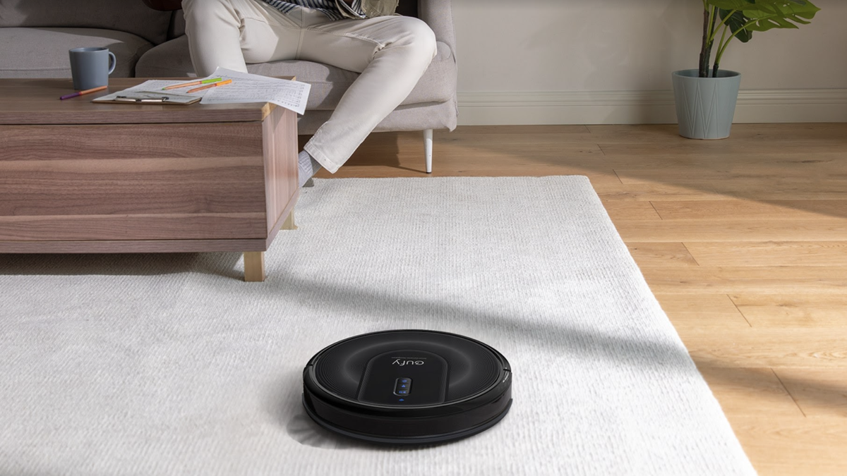 Eufy RoboVac G30 Verge cleaning cream carpet next to user