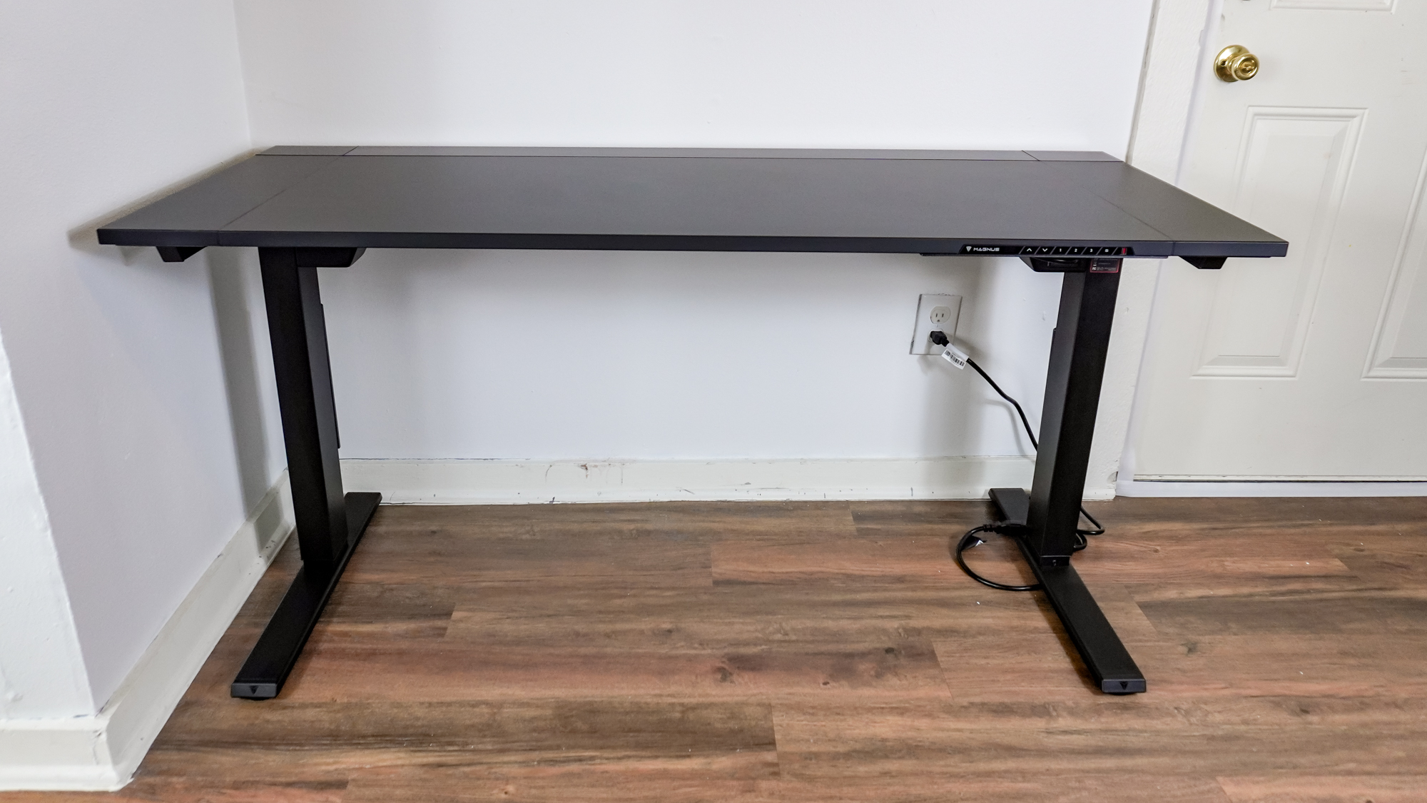 The Secretlab Magnus Evo standing desk plugged into a wall