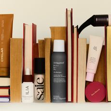 books and an arrangement of makeup hair and skincare products