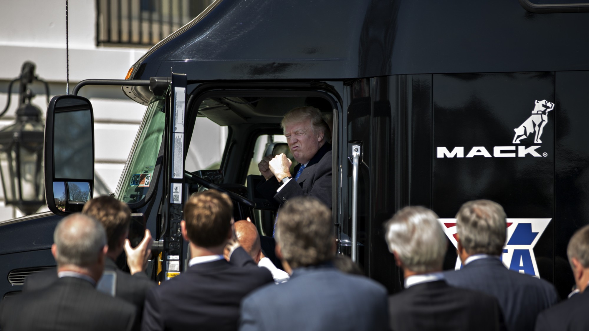 U.S. President Donald Trump sits in the cab of a tractor trailer during an event with truckers and truck industry chief executive officers on the South Lawn of the White House in Washington, D.C., U.S., on Thursday, March 23, 2017. House leaders delayed a scheduled vote on their embattled health-care bill as conservatives mulled a deal proposed by the Trump administration aimed at winning Republican holdouts support. Photographer: Andrew Harrer/Bloomberg via Getty Images