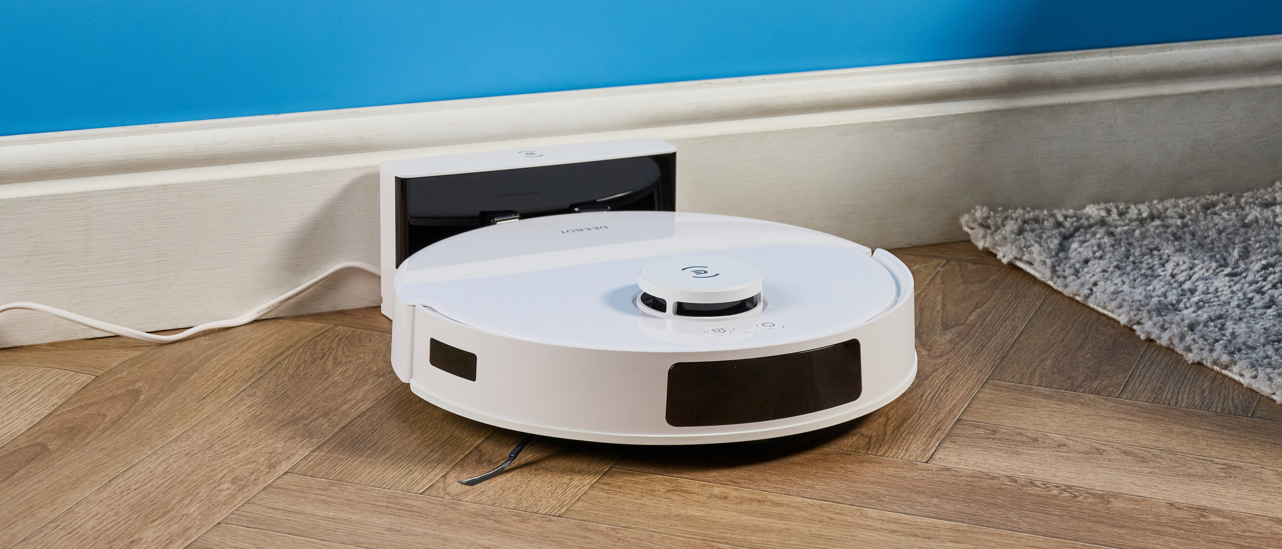 Ecovacs Deebot N20 in white photographed vacuuming floor