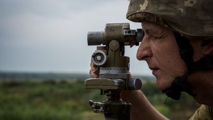 A Ukrainian soldier prepares to fire a GRAD rocket launcher