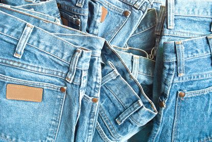 Pile of light denim jeans