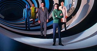 Five men standing inside a spiraling tunnel