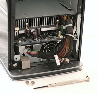 Push down on the cable bundle at the upper right to ease removal of the motherboard tray