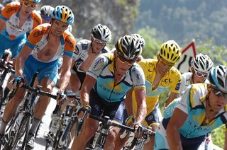Lance Armstrong riders near yellow jersey Alberto Contador on the Côte d'Araches. David Millar (Garmin-Slipstream) rides in front of teammate Bradley Wiggins.
