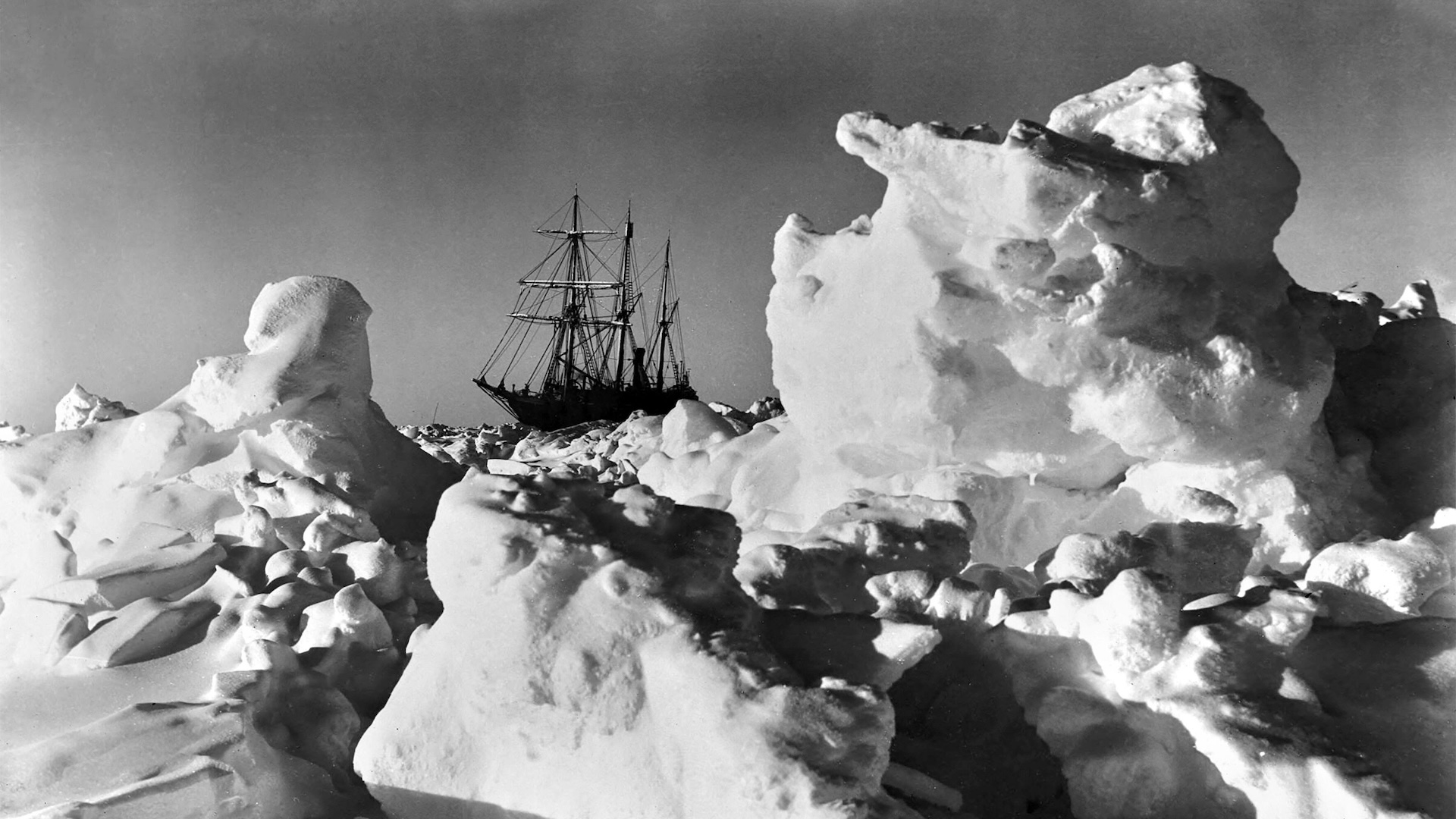 A black-and-white photo of the Shackleton ship trapped on huge ice formations