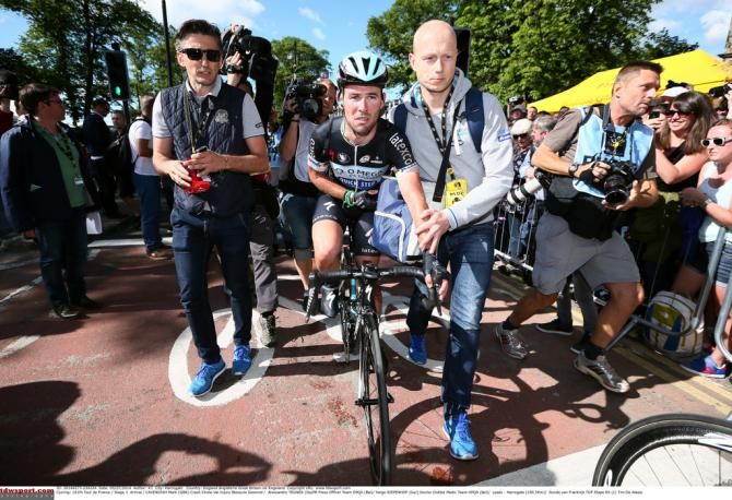 Mark Cavendish (Omega Pharma-Quickstep) escorted after crashing in the finale