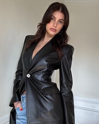 @camilamorrone in a leather jacket with a '90s layered haircut