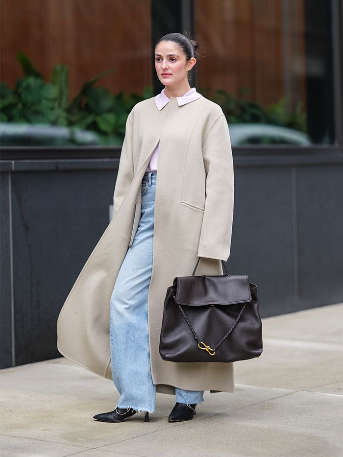 Woman carrying a Bottega Veneta Ciao Ciao bag.